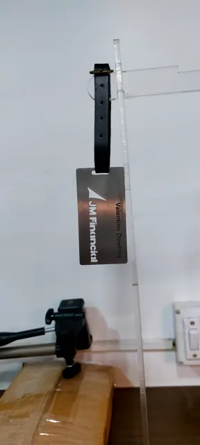 JM Financial luggage tag with a name engraved on the back