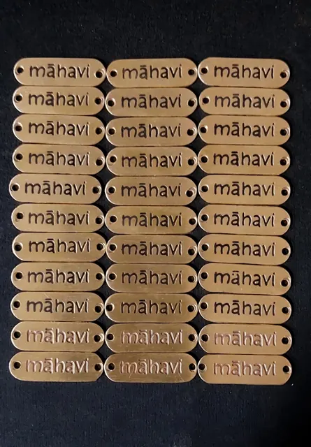 Rows of brass mahavi logo labels
