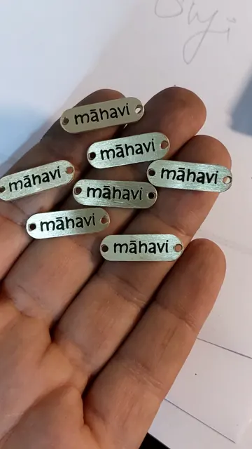 Mahavi brass labels held in hand