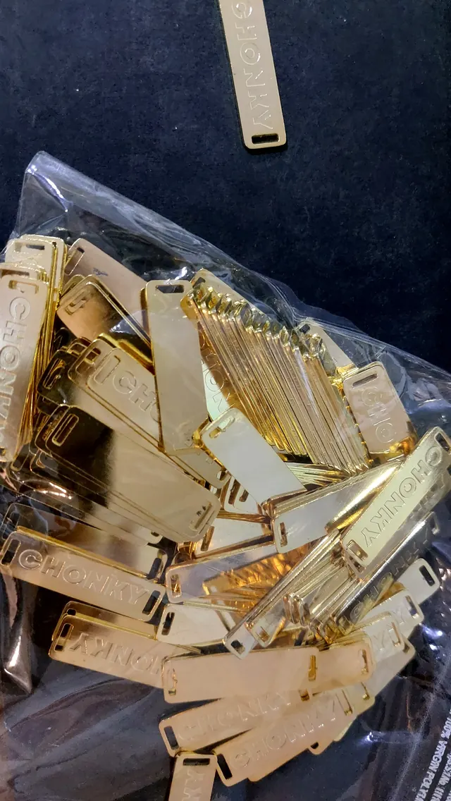 Bag of polished brass labels