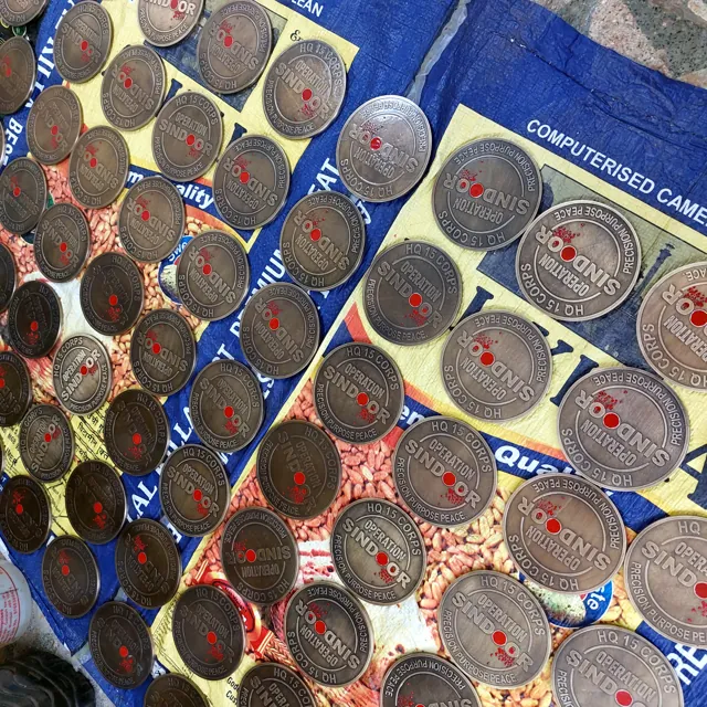 A production batch of Operation Sindoor coins laid out for checking