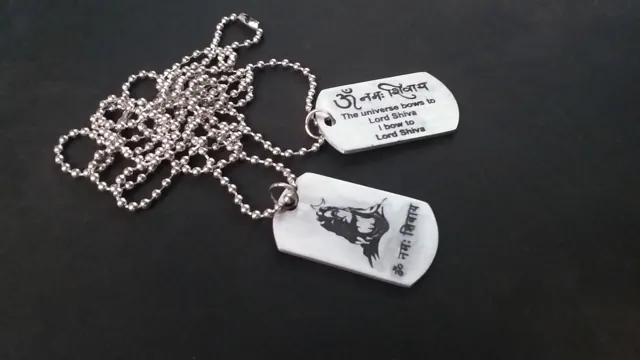 Two dog tags with Lord Shiva artwork and Hindi text