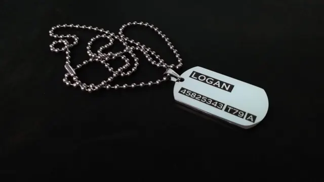 Dog tag engraved with a name, service number and blood group in classic military style