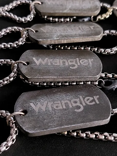 Close-up of antique steel Wrangler dog tags on box chains
