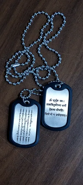 Dog tags in black silencers engraved with Sanskrit and Hindi verses