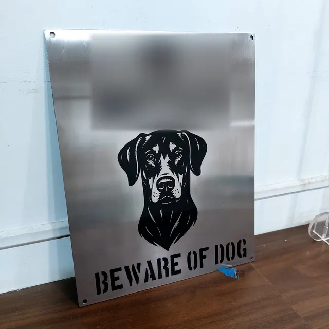 Stainless steel house sign with dog portrait, name blurred